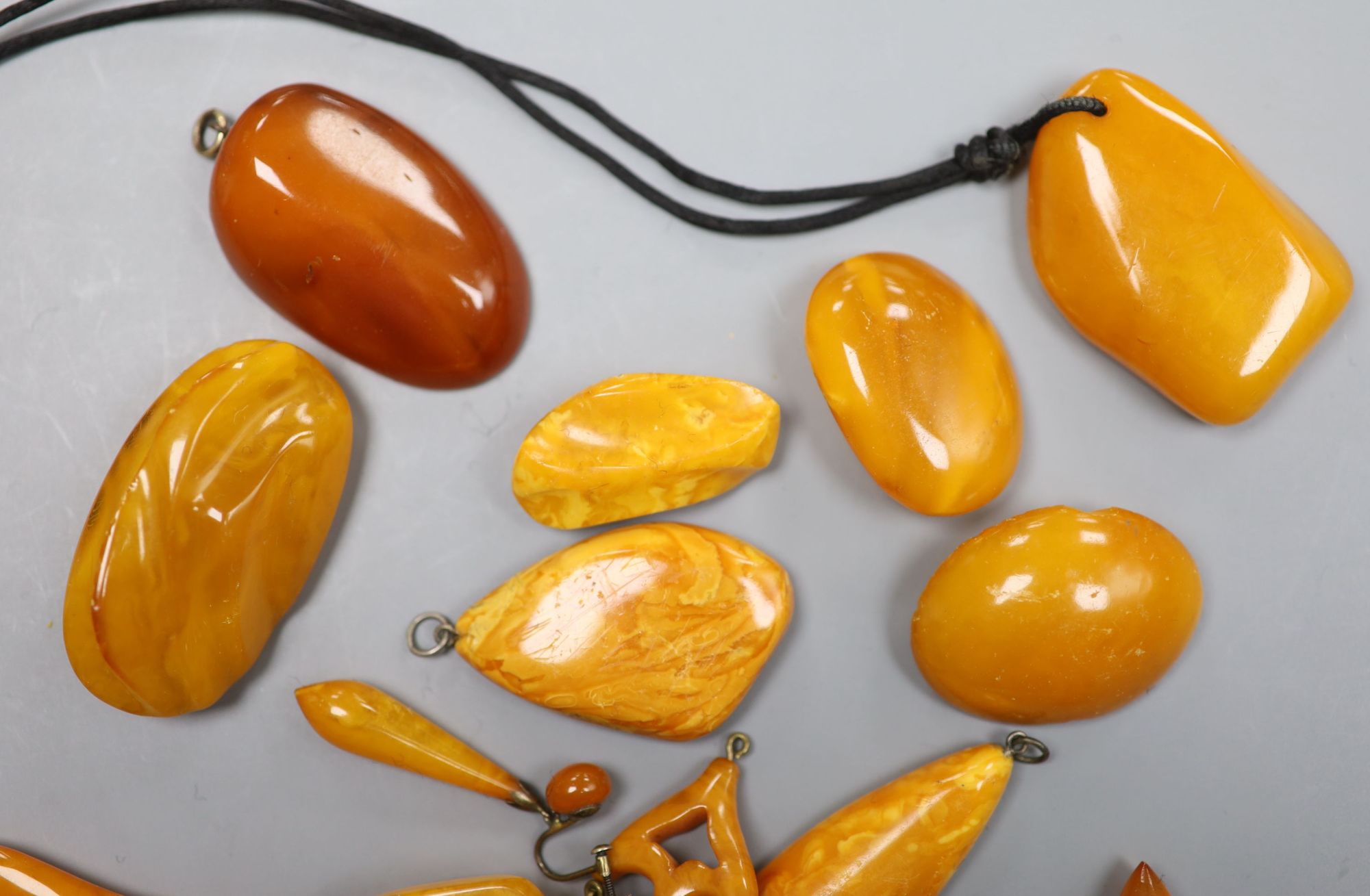 A group of assorted amber jewellery including, earrings, brooches and pendants, gross weight 136 grams.